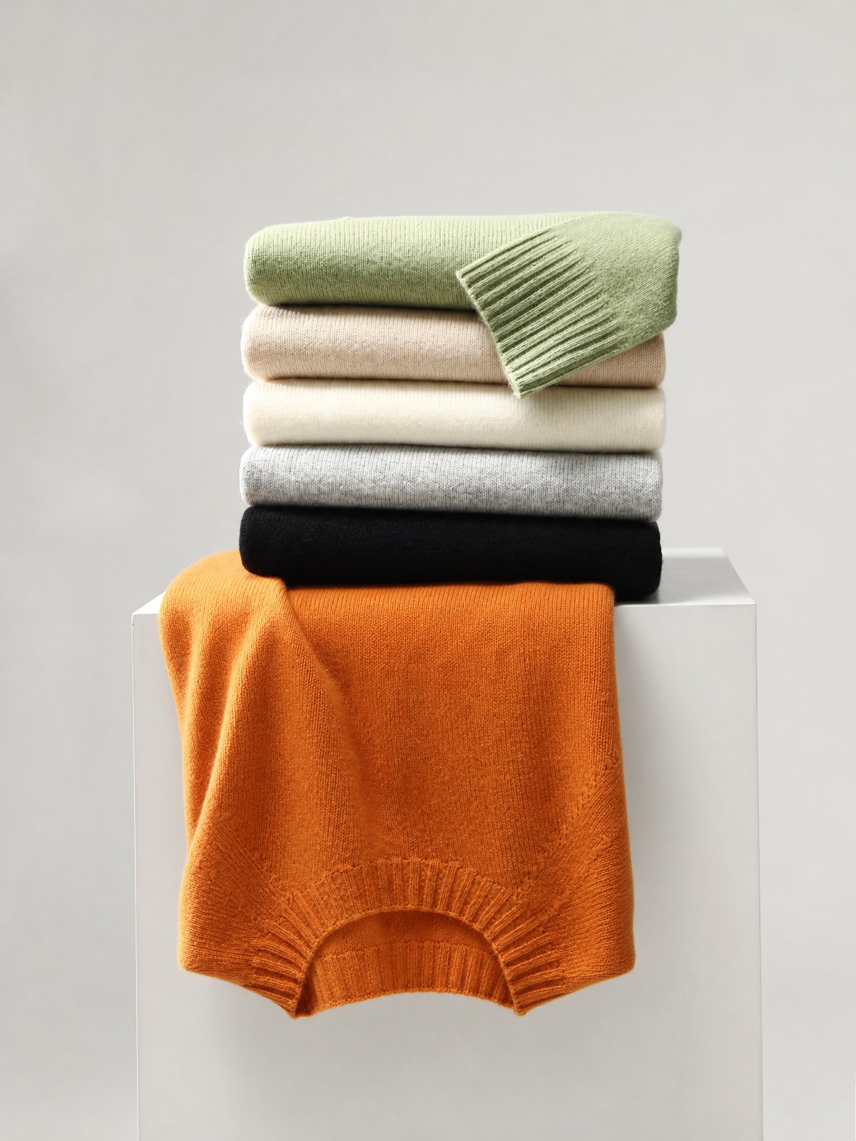 Folded cashmere sweaters in soft natural colors