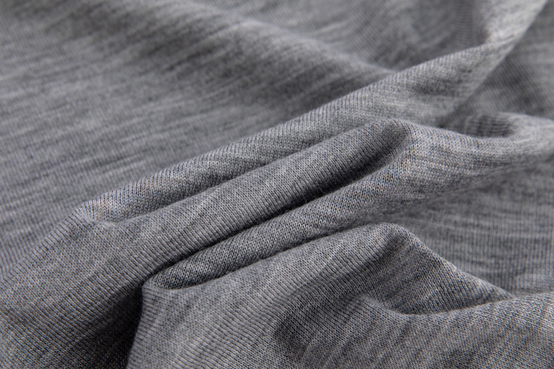 Close view of smooth grey worsted knit fabric